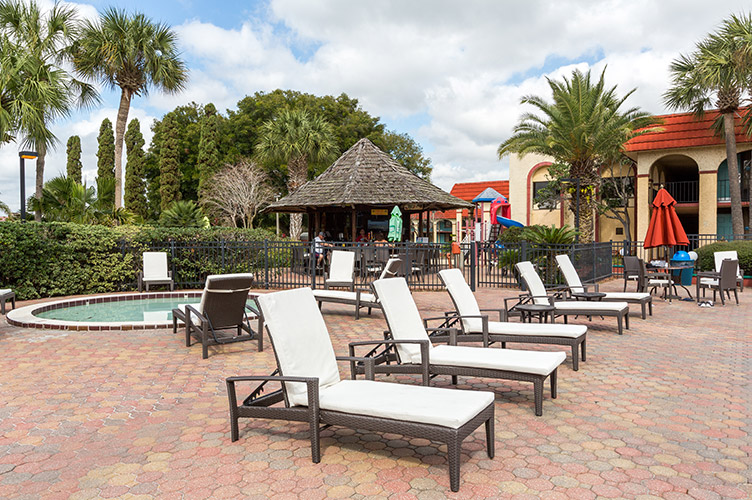 Exterior shot of a loung chair poolside at our family friendly Kissimmee, FL resort